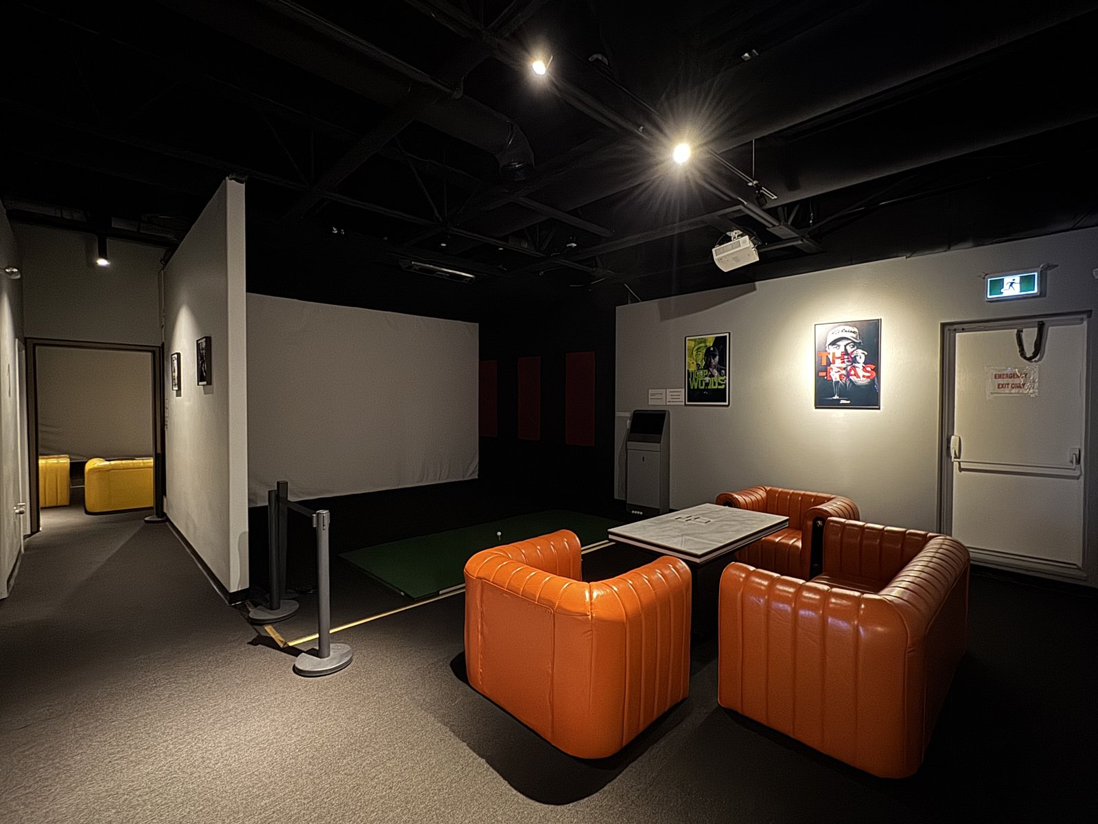 Golf O'Clock — simulator bay with lounge seating